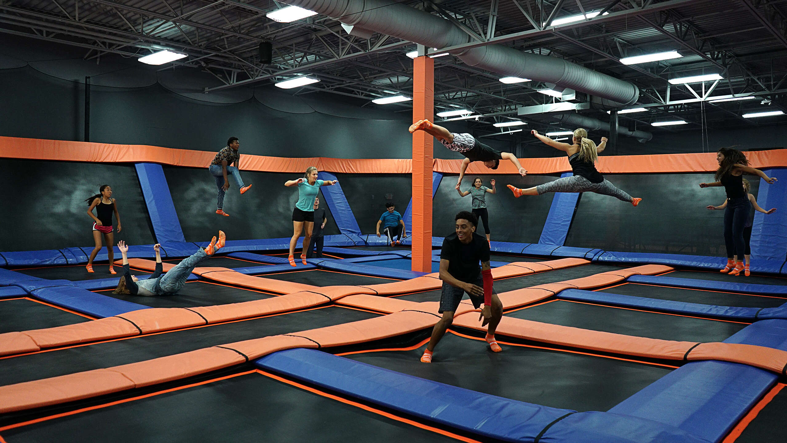 Multiple kids jumping at a SkyZone Trampoline Park.