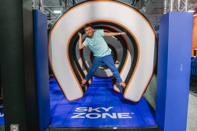 Teen enjoying a Sky Zone indoor attraction